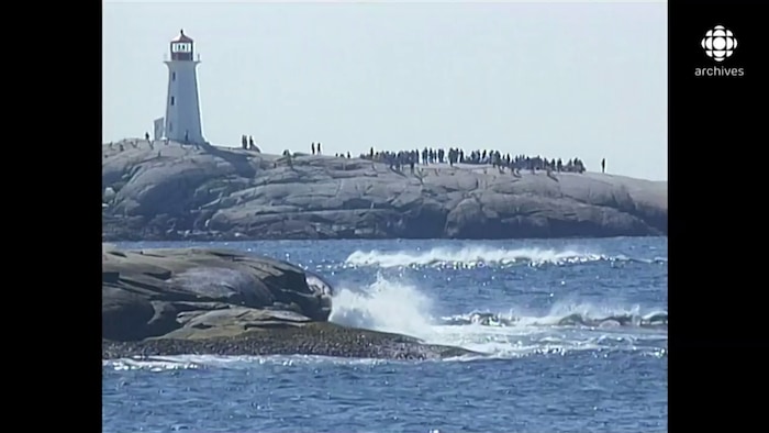 Des familles des victimes se recueillent sur les rochers à côté du phare de Peggy's Cove.