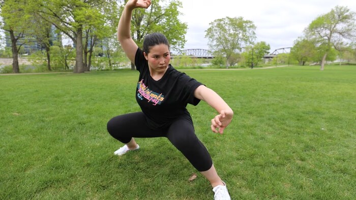 Banin Arjmand practices the flowing movements of Wushu, a style of martial arts, in Saskatoon's Rotary Park. Arjmand learned Wushu at Marefat High School in Kabul, Afghanistan. (Don Somers/CBC)