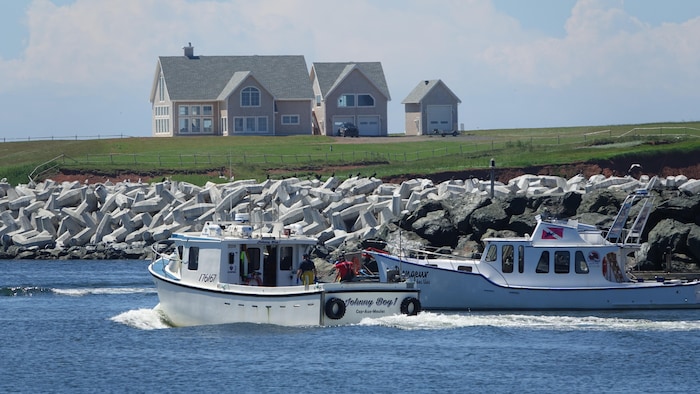 Des bateaux sortent du port de L'Étang-du-Nord.