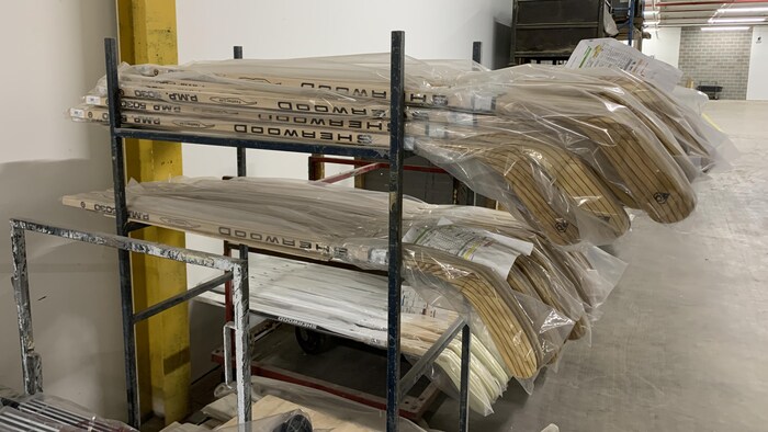 Hockey sticks stored on the shelves.