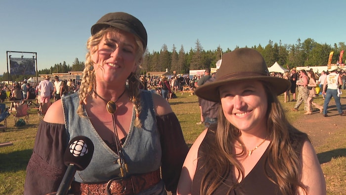 Deux musiciennes en plein air sur le site d'un festival.