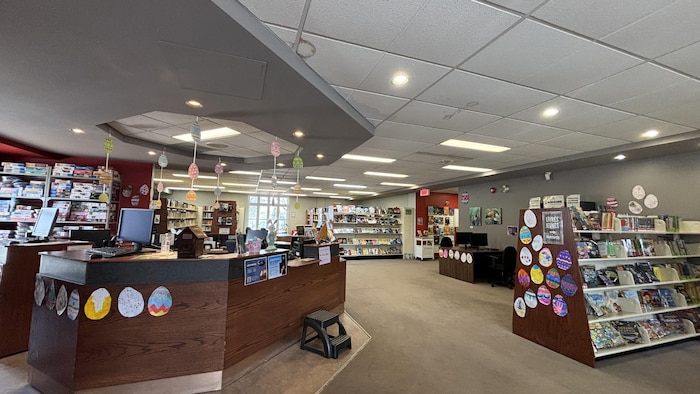 Des rangées de livres et un bureau à la réception.