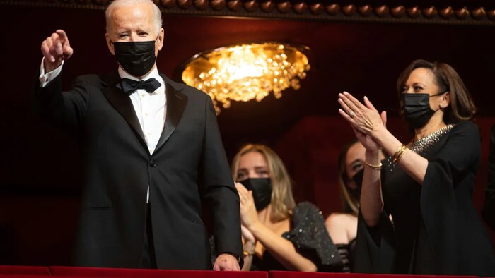 U.S. President Joe Biden points to the crowd as he and Vice-President Kamala Harris are introduced during the honours gala at the John F. Kennedy Center for the Performing Arts. 