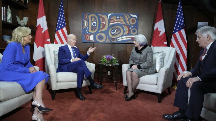 U.S. President Joe Biden speaks as he and First Lady Jill Biden, left, meet with Gov. Gen. Mary Simon, second from right, and her husband Whit Fraser, right, at Ottawa International Airport on Thursday in Ottawa. (Andrew Harnik/The Associated Press)