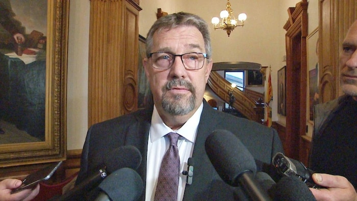 Bill Hogan speaks to reporters.