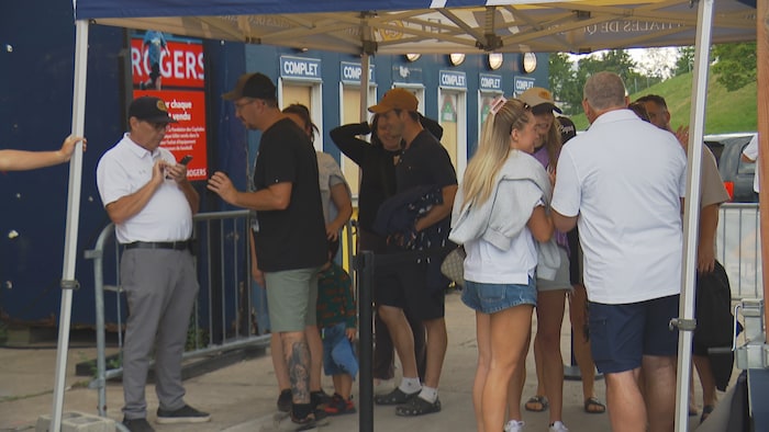 Employees are scanning spectators' tickets.