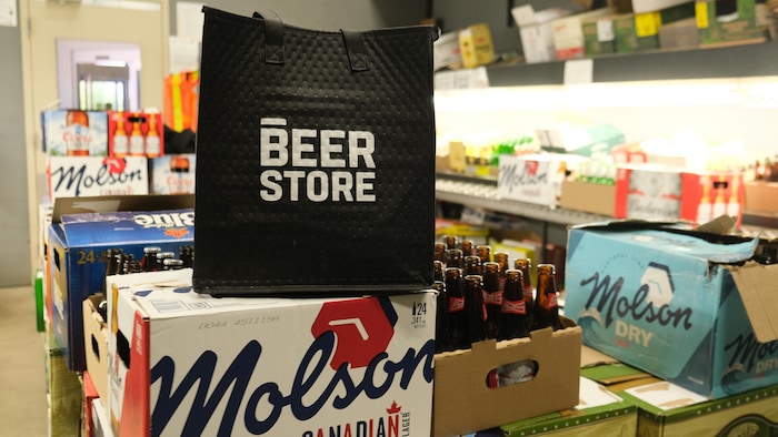 A Beer Store bag in a room with several boxes of beer. what future beer store stores