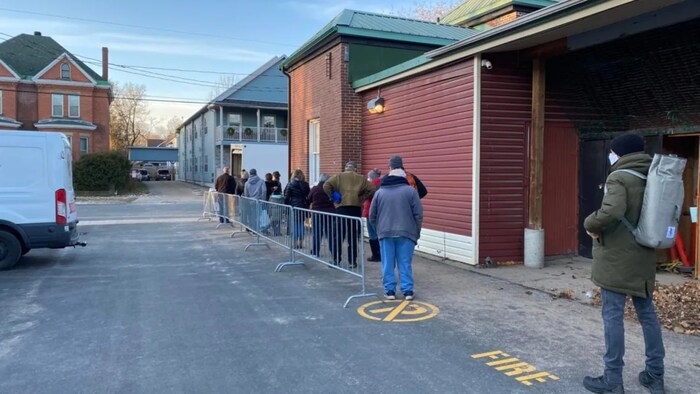 Shoppers lined up at the Boyce Famers Market in Fredericton the day after the province changed the rules about asking for proof of vaccination. 