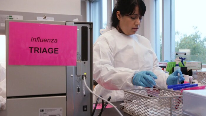 A lab technician works in the H1N1 laboratory at the British Columbia Centre for Disease Control in Vancouver in 2009. This year's flu season started earlier than the norm. 