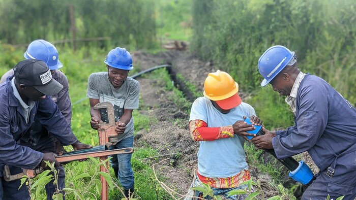 Un groupe d'ouvriers raccordent des conduites d'eau en Ouganda dans le cadre d'un projet administré par Acts for Water, une organisation caritative de Vancouver. 