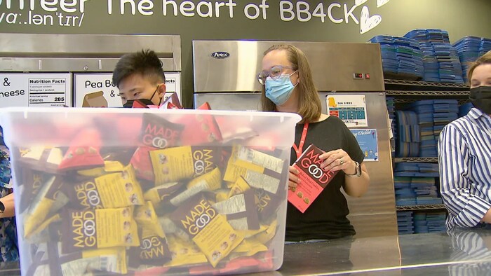 Des bénévoles distribuent des dons dans un local de l'organisme de bienfaisance,  Brown Bagging for Calgary's Kids.