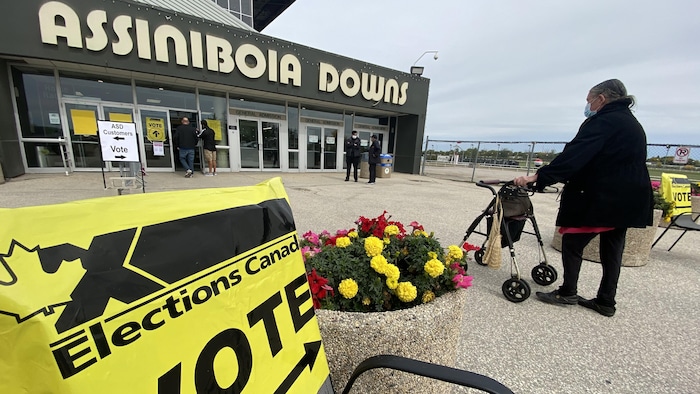 Woman using a walker is about to enter polling station at Assiniboia Downs, Manitoba.