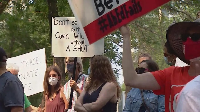 Members of Alberta's medical community who are unhappy with the province's plan demonstrate in Calgary on Friday. There was also a protest at the legislature in Edmonton.