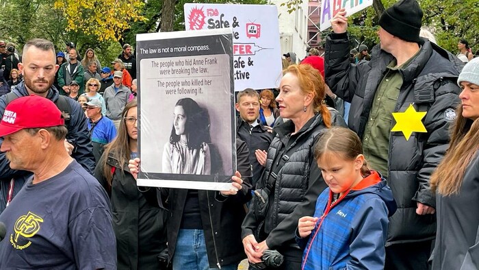 Protesters in Calgary held signs in a September 2021 rally that compared the plight of Jewish victims of the Holocaust to workers being asked by employers to get vaccinated for COVID-19. The comparison drew condemnation from politicians, people in the Jewish community and others. 