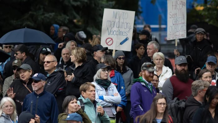 Protesters met at Olympic Plaza, where some speakers shared misinformation about COVID-19 case counts and the accuracy of PCR tests, before marching through downtown. (Brooks DeCillia/CBC)