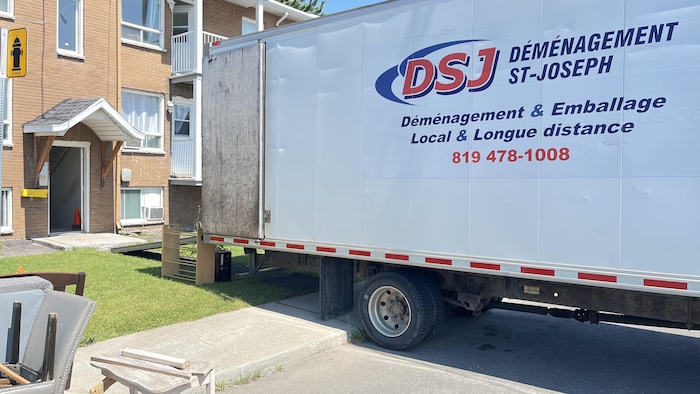 Un camion de déménagement devant un immeuble à Drummondville.