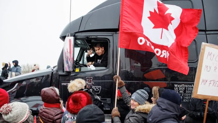 Supporters of an anti-vaccine mandate protest convoy bound for Ottawa cheer at the Vaughn Mills outlet mall in Vaughn, Ont., on Jan. 27, 2022. 
