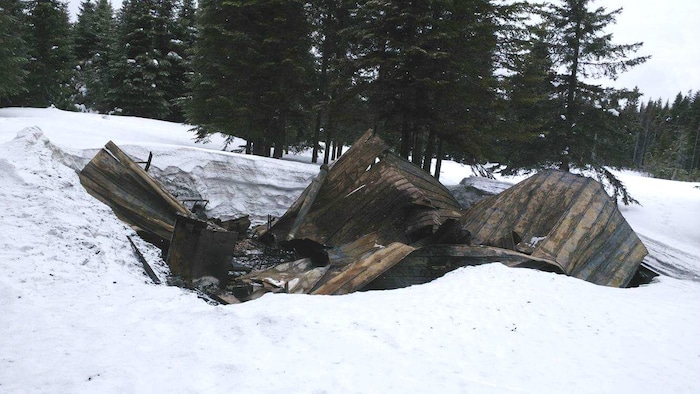 Camp de chasse carbonisé dans la neige.