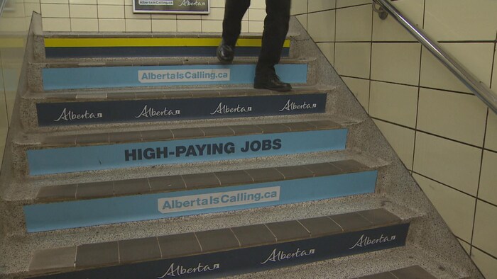 Des affiches du gouvernement de l'Alberta collées sur les marches du métro.