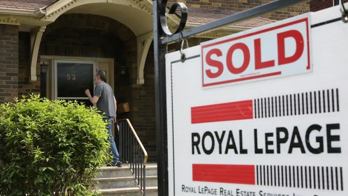 A realtor's sign stands outside a house in Toronto on May 20, 2021.