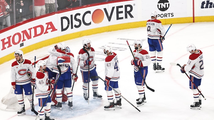Des joueurs du Canadien entourent le gardien Jakub Dobes.