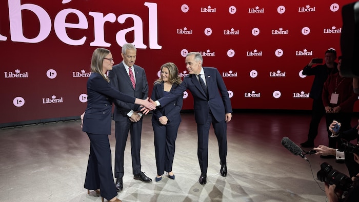 Les quatre candidats à la chefferie du Parti libéral du Canada se saluent avant le début du débat en anglais, le 25 février 2025.