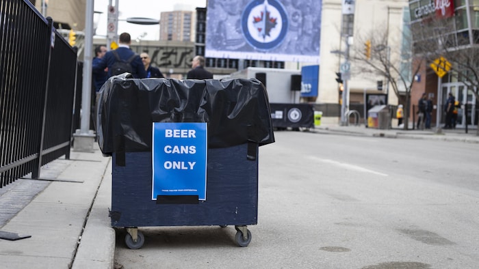Une poubelle pour des canettes de bière en pleine rue.