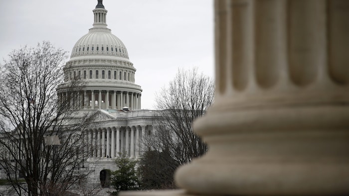 Le Capitole de Washington vu de l'extérieur sous un ciel gris.