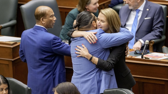 Le député néo-démocrate Sol Mamakwa serre dans ses bras Caroline Mulroney, qui a démissionné du cabinet Ford, dans l’hémicycle de l’Assemblée législative à Queen’s Park, à Toronto, le 2 juin 2026.