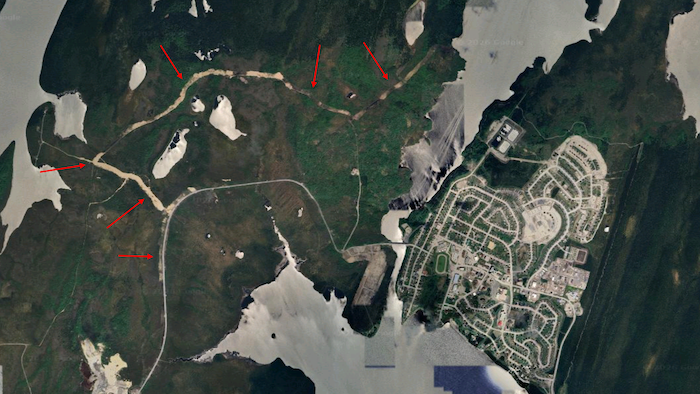 Une carte satellite sur laquelle on distingue la communauté et des traits plus clairs qui représentent des barrières antifeux.
