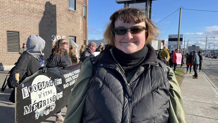 Cassandre Vassart-Courteau se tient devant des manifestants.