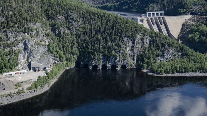 The six water outlets of the Manic-3 power plant from an aerial view.  The dam is in the right corner of the photo.