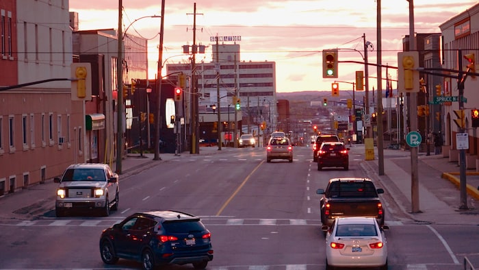 سيارات وإشارات مرورية وأبنية في وسط مدينة تيمينز.