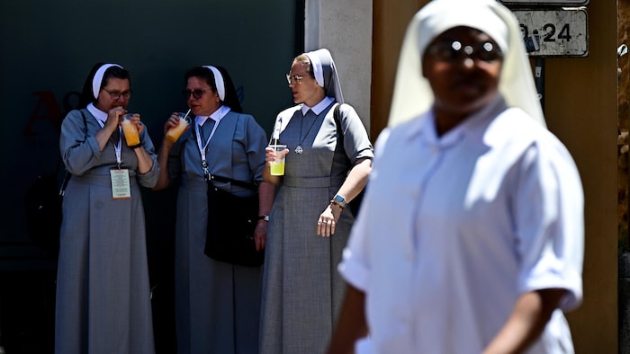 Nuns stand in the shade to savor cold heat waves southern europe: health drinks by a hot summer day, in Rome, near the Vatican, June 28, 2025. Nevertheless,