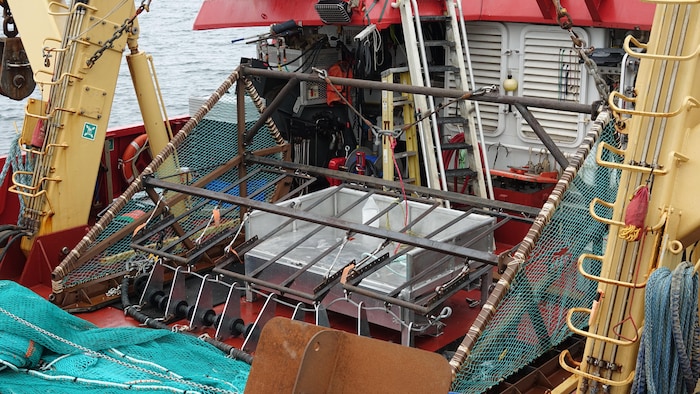 The metal structure of a chalut poses on the pontoon of a ship.