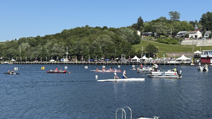 Plusieurs canoës-kayaks sur le lac par une journée d'été chaude et sans nuage.