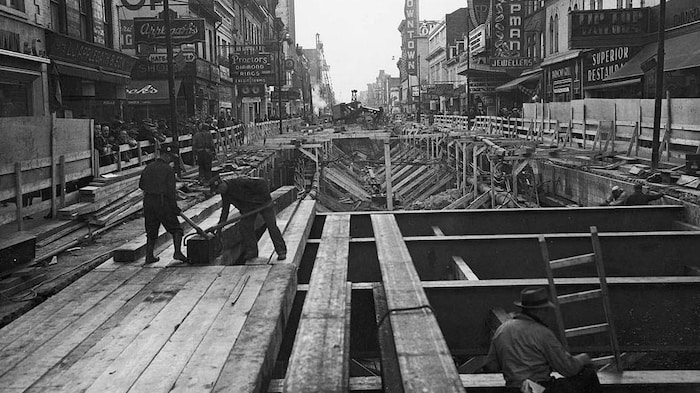 Photo en noir et blanc qui montre la rue Yonge complètement éventrée et quelques travailleurs à l'ouvrage