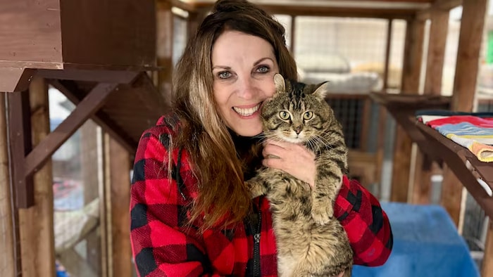 Veronica Hermiston pose avec un autre chat recueilli par son organisme.