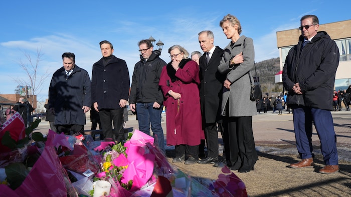 NDP interim Leader Don Davies, from left, Conservative Leader Pierre Poilievre, MP Bob Zimmer, Green Party Leader Elizabeth May, Prime Minister Mark Carney and his wife Diana Fox Carney, and Bloc Quebecois Leader Yves-Francois Blanchet attend a memorial for the victims of a mass shooting, in Tumbler Ridge, B.C., Friday, Feb. 13, 2026.