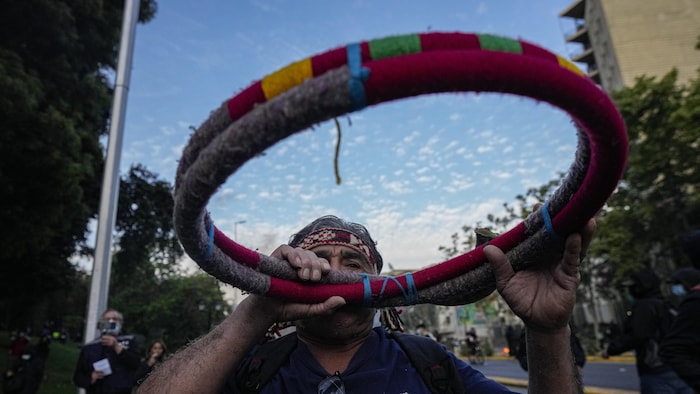 Mapuche Indigenous man plays a Trutruca during a protestprotests against Chile's President Sebastian Piñera in Santiago, Chile, Thursday, Nov. 4, 2021. The protests come after one Indigenous person was shot dead during clashes in the southern region of Biobio after the Chilean government had decreed a state of emergency and mobilized government forces in an attempt to reduce ongoing violence. (AP Photo/Esteban Felix)