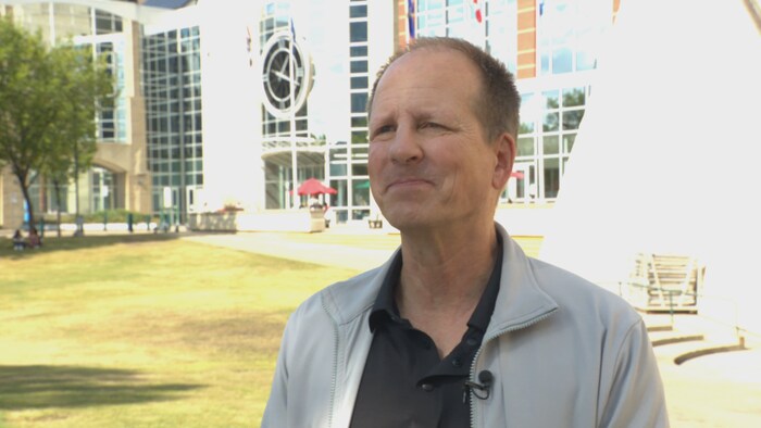 Chris Hay en entrevue à Radio-Canada devant l'édifice de l'Université MacEwan à Edmonton.