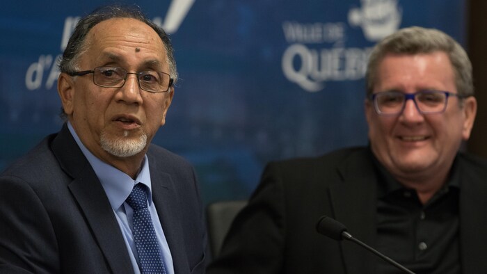 Benabdallah, left, signed a land purchase agreement with former Quebec City mayor Régis Labeaume, right, in 2019 that allowed the cemetery to be built in the Sainte-Foy neighbourhood where the 2017 shooting at a mosque claimed the lives of six people.