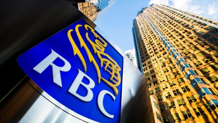 Royal Bank sign in front of two very tall buildings.