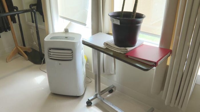 Un climatiseur portatif dans une chambre d'un foyer de soins. 