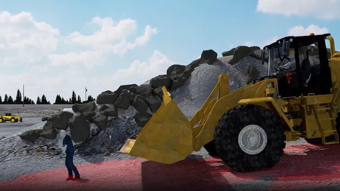 Une simulation montre un piéton sur un chantier et une chargeuse qui s'approche derrière lui.