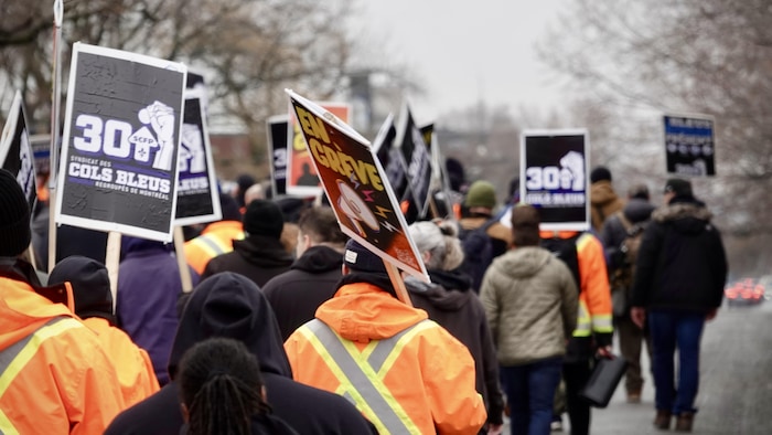 Des manifestants de la Ville de Montréal marchent dans les rues.