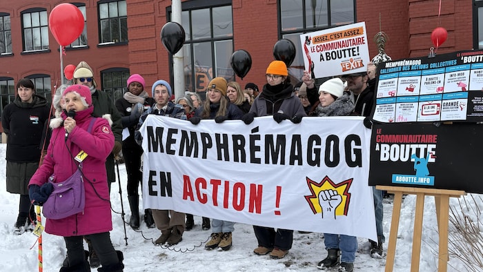 Des gens mobilisés affichant « Memphrémagog en action! »