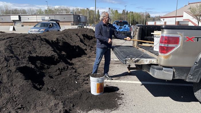 Un homme recueillant du compost
