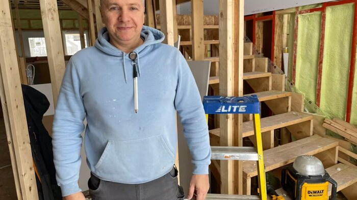 Maksym Bilam, a construction worker originally from Ukraine, works on a home under construction in Moncton. (Alexandre Silberman/CBC)