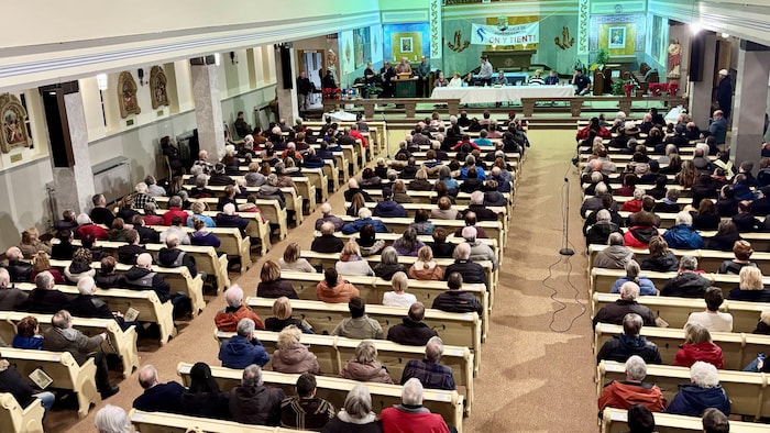 Différentes personnes réunies lors d'une rencontre de consultation dans une église.